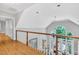 View of the light filled hallway, staircase and living space below at 4817 Fox Branch Ct, Raleigh, NC 27614