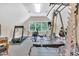 Bright home gym with various machines, including a treadmill, rowing machine, and weightlifting equipment at 4817 Fox Branch Ct, Raleigh, NC 27614