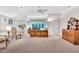 Bright home office with a large wooden desk, neutral carpet, and a ceiling fan for added comfort at 4817 Fox Branch Ct, Raleigh, NC 27614
