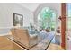 Spacious living room featuring large windows, a fireplace, and comfortable seating at 4817 Fox Branch Ct, Raleigh, NC 27614