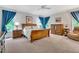 Spacious main bedroom features a large bed, matching nightstands, and natural light from the large windows at 4817 Fox Branch Ct, Raleigh, NC 27614