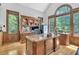 Bright office with custom desk, built-in bookshelves, and ample natural light at 4817 Fox Branch Ct, Raleigh, NC 27614
