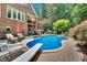 Inviting backyard pool with patio, diving board, and lush landscaping at 4817 Fox Branch Ct, Raleigh, NC 27614