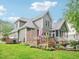 Exterior view of the home showcasing the wooden deck and lush green lawn at 5720 Brushy Meadows Dr, Fuquay Varina, NC 27526