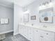 Bright bathroom with double vanity, classic white cabinetry, framed mirrors, and stylish tile flooring and rugs at 5720 Brushy Meadows Dr, Fuquay Varina, NC 27526