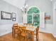 Elegant dining room with a large arched window and chandelier at 5720 Brushy Meadows Dr, Fuquay Varina, NC 27526