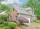 A two-story home with brick and siding exterior, featuring a mature Japanese Maple tree in the landscaped yard at 5720 Brushy Meadows Dr, Fuquay Varina, NC 27526