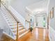Inviting foyer with hardwood floors, staircase, and natural light from the front door at 5720 Brushy Meadows Dr, Fuquay Varina, NC 27526