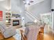 Cozy living room featuring a brick fireplace, comfortable seating, and staircase at 5720 Brushy Meadows Dr, Fuquay Varina, NC 27526