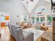 Open concept living area with a brick fireplace, hardwood floors, and natural light at 5720 Brushy Meadows Dr, Fuquay Varina, NC 27526