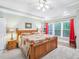 Inviting main bedroom with tray ceiling, neutral decor, large window, and carpeted floor at 5720 Brushy Meadows Dr, Fuquay Varina, NC 27526