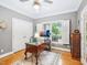 Home office with a large window, classic desk, and a neutral color scheme at 5720 Brushy Meadows Dr, Fuquay Varina, NC 27526