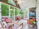 Spacious screened porch featuring a variety of seating options and pleasant views of the surrounding greenery at 5720 Brushy Meadows Dr, Fuquay Varina, NC 27526