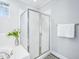 Enclosed glass shower stall with decorative tile and towel rack in a well-lit bathroom at 5720 Brushy Meadows Dr, Fuquay Varina, NC 27526