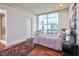 Bright bedroom with large windows, hardwood floors, and a calming neutral color palette at 601 W Rosemary St # 712, Chapel Hill, NC 27516