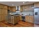 Modern kitchen with wood cabinets, stainless steel appliances, and a central island, offering a stylish cooking space at 601 W Rosemary St # 712, Chapel Hill, NC 27516