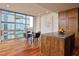 Open kitchen with wood cabinets, island, hardwood floors and large windows offering natural light with great views at 601 W Rosemary St # 712, Chapel Hill, NC 27516