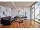 Modern living room featuring hardwood floors, contemporary decor, and ample natural light at 601 W Rosemary St # 712, Chapel Hill, NC 27516