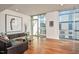 Bright living room with large windows, hardwood floors, and stylish modern furnishings at 601 W Rosemary St # 712, Chapel Hill, NC 27516