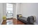 Small sitting room featuring hardwood floors, bright natural light, and cozy seating at 601 W Rosemary St # 712, Chapel Hill, NC 27516