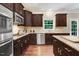 Well-equipped kitchen with stainless appliances, granite countertops, and abundant natural light at 62 Jubilee Ct, Clayton, NC 27527