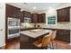 Stylish kitchen featuring stainless appliances, a granite island, and dark wood cabinetry at 62 Jubilee Ct, Clayton, NC 27527