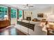 Comfortable living room with fireplace, ceiling fan, and large windows overlooking the backyard at 62 Jubilee Ct, Clayton, NC 27527