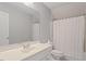 Bright bathroom with a wide mirror, single sink vanity and a shower with curtain at 6335 Cedar Waters Dr, Raleigh, NC 27607