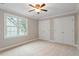 Cozy bedroom featuring a window view, two closets, and neutral paint, perfect for relaxation at 6335 Cedar Waters Dr, Raleigh, NC 27607