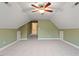 Large bonus room with vaulted ceilings, neutral carpet, and built-in storage options, great for organization at 6335 Cedar Waters Dr, Raleigh, NC 27607