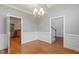 Bright dining room with chandelier lighting, detailed trim, and hardwood floors at 6335 Cedar Waters Dr, Raleigh, NC 27607