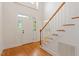 Bright foyer with hardwood floors and a staircase, leading into the main living area at 6335 Cedar Waters Dr, Raleigh, NC 27607