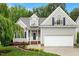 Charming home featuring a landscaped front yard, two-car garage, and a welcoming entrance at 6335 Cedar Waters Dr, Raleigh, NC 27607