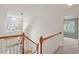 Upstairs hallway with hardwood railings leads to a bedroom at 6335 Cedar Waters Dr, Raleigh, NC 27607