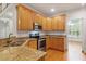 This kitchen features stainless steel appliances, lots of wooden cabinets, and granite countertops at 6335 Cedar Waters Dr, Raleigh, NC 27607