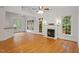 An open-concept living room with fireplace and large windows at 6335 Cedar Waters Dr, Raleigh, NC 27607