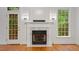 Living room with fireplace, hardwood floors, and lots of natural light at 6335 Cedar Waters Dr, Raleigh, NC 27607