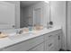 Bathroom featuring a double vanity with a large mirror at 6352 Perry Creek Rd, Raleigh, NC 27616