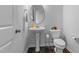 Bright bathroom with pedestal sink, oval mirror, and neutral decor at 6352 Perry Creek Rd, Raleigh, NC 27616