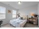 Bedroom featuring a plush bed, side tables with lamps, and windows providing soft natural light at 6352 Perry Creek Rd, Raleigh, NC 27616