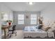 Comfortable bedroom with a plush bed, a writing desk near windows, and soft natural lighting at 6352 Perry Creek Rd, Raleigh, NC 27616