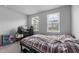 Bedroom with a cozy bed, windows with blinds for natural light, and a computer gaming setup at 6352 Perry Creek Rd, Raleigh, NC 27616