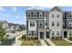 Charming two-story townhome featuring stone accents, neutral siding and well-manicured landscaping at 6352 Perry Creek Rd, Raleigh, NC 27616