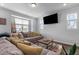 Comfortable living room featuring a large sectional sofa, TV, and neutral decor at 6352 Perry Creek Rd, Raleigh, NC 27616
