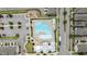 Aerial view of a community pool with lounge chairs, tables, a playground, and parking at 6352 Perry Creek Rd, Raleigh, NC 27616
