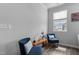 Inviting sitting area with two armchairs, wooden accent table, and a window view at 6352 Perry Creek Rd, Raleigh, NC 27616