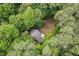 Aerial view of the home nestled in a lush wooded area at 6412 Heartwood Dr, Chapel Hill, NC 27516
