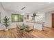 Dining area with modern lighting, open kitchen access, hardwood flooring, and views of the outdoors at 6412 Heartwood Dr, Chapel Hill, NC 27516
