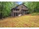 Beautiful rear exterior of home with screened-in porch, generator, and a wooded lot at 6412 Heartwood Dr, Chapel Hill, NC 27516