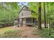 Exterior view of home surrounded by lush greenery and mature trees at 6412 Heartwood Dr, Chapel Hill, NC 27516